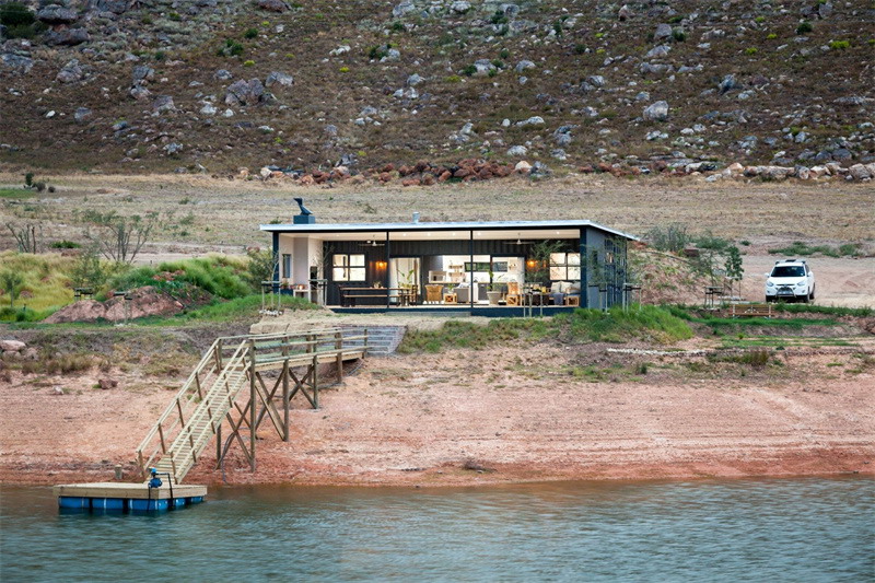 Container house | I used half of the house to build the terrace, it turns out that the terrace near the water is a luxury house!